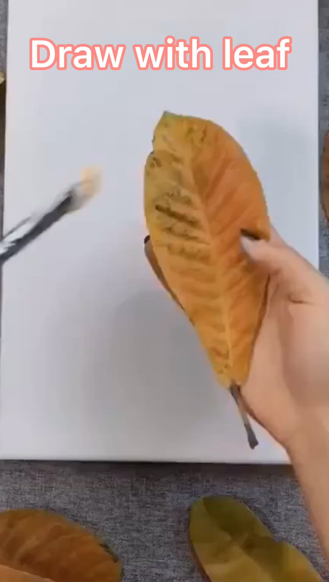 This may contain: a person is cutting into a leaf with scissors