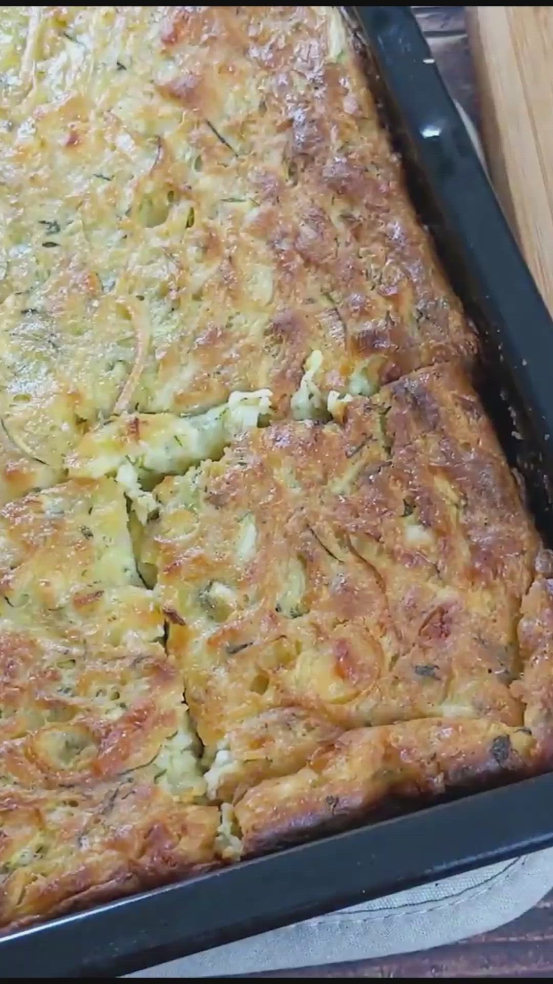 This contains: Video with steps on how to prepare Zucchini Pie