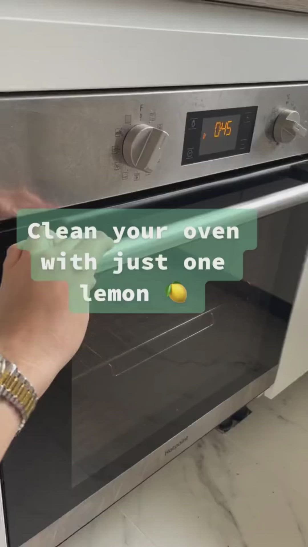 This may contain: a person is pulling something out of an oven with the words clean your oven with just one lemon