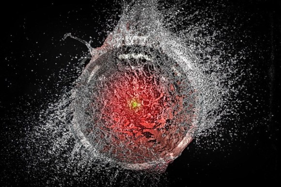 A popping water-balloon, caught mid-burst. Superimposed over it is the hostile glaring eye of HAL9000 from Stanley Kubrick's '2001: A Space Odyssey.'