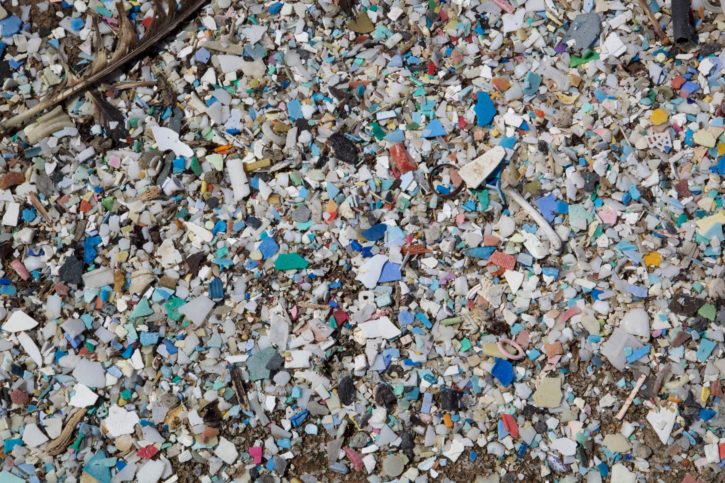 An aerial photo of the Pacific Gyre Garbage Patch, acres of floating, immortal plastic bottles.