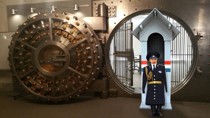 A bank fault. In front of the vault is a guardhouse. it is guarded by a crying baby in an impressive, oversized uniform