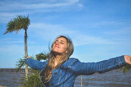 women's wearing blue button-up chambray jacket