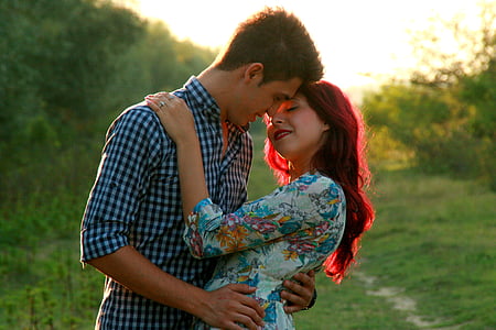 man and woman hugging each other in shallow focus photography