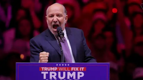 Howard Lutnick, Chairman and CEO of Cantor Fitzgerald, clenches his fist as he speaks during a rally for Republican presidential nominee and former U.S. President Donald Trump at Madison Square Garden, in New York, U.S., October 27, 2024. 