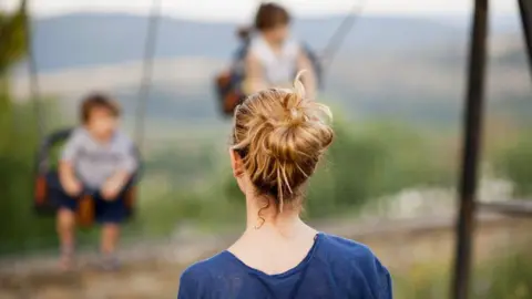 Stock image of a mother looking at a child