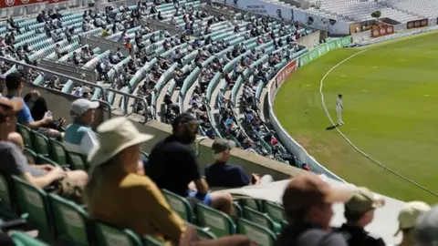 AFP Spectators watch cricket