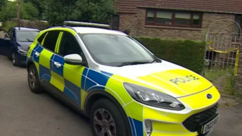 A police car outside a house