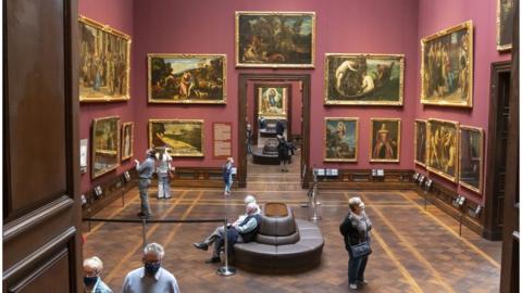 museum visitors wearing face masks.