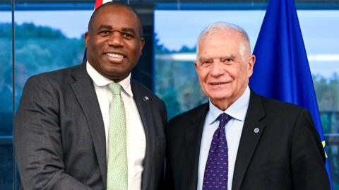 EU High Representative for Foreign Affairs and Security Policy Josep Borrell (R) welcomes Foreign Secretary David Lammy (L) at the start of the European Foreign Affairs Council in Luxembourg City