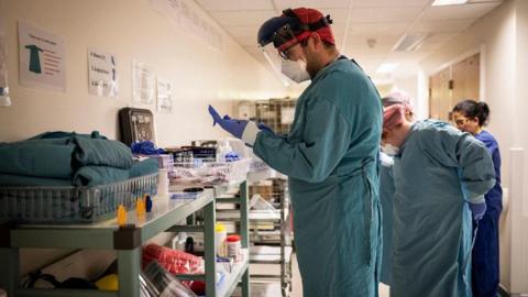 Medical staff wearing protective medical equipment before entering Covid intensive care ward at University Hospital Coventry on May 25, 2020 in Coventry, United Kingdom. 