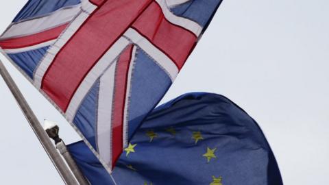 A Union Jack pictured next to the European Union flag