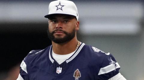 Dallas Cowboys quarterback Dak Prescott looks on in training