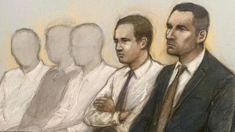 A court sketch showing two defendants wearing suits with the three other undefined defendants in the background.