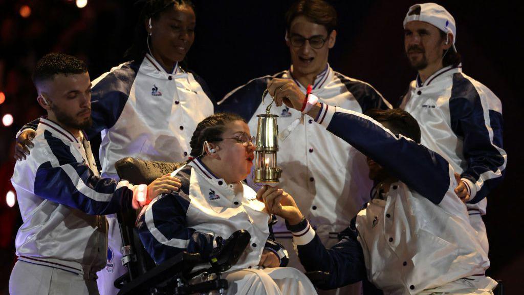 Aurelie Aubert of Team France blows out the Olympic Flame during the closing ceremony 