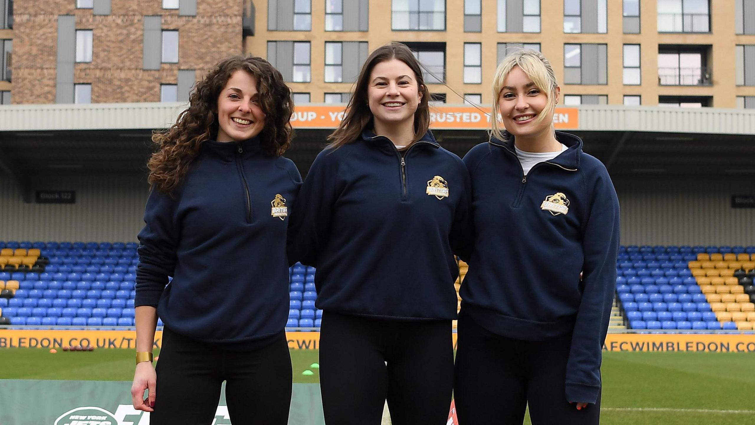 Kate Bruinvels, Ellie Thorpe and Kellie Barrett pose at the Cherry Records Stadium in Wimbledon