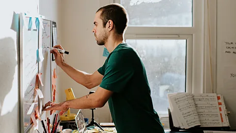 Man writing on whiteboard (Credit: Getty Images)