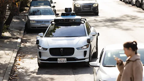 A Waymo robotaxi pulls over on a street in San Francisco (Credit: Getty Images)