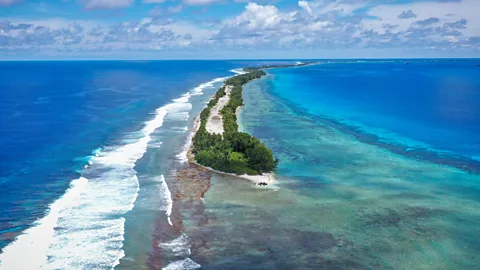 A long thin strip of land covered in forests sits within the ocean (Credit: Getty Images)