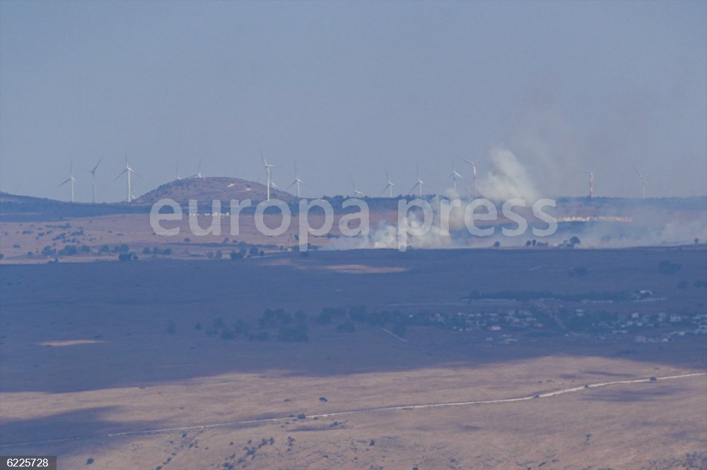 GOLAN HEIGHTS, Sept. 20, 2024  -- Smoke billows from an area hit by rockets launched from Lebanon, in the Israeli-occupied Golan Heights, on Sept. 20, 2024. Hezbollah launched over 100 rockets at more than 30 settlements in western Galilee and a key intelligence base in northern Israel on Friday, retaliating for an Israeli airstrike on Beirut's southern suburbs that killed at least 12 people and wounded 66 others, according to the Lebanese Health Ministry.