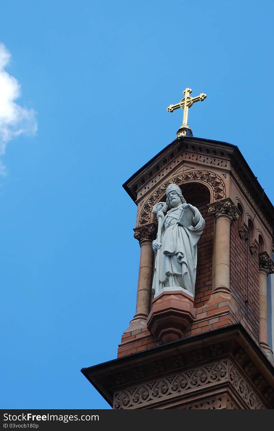 Figure and cross on church