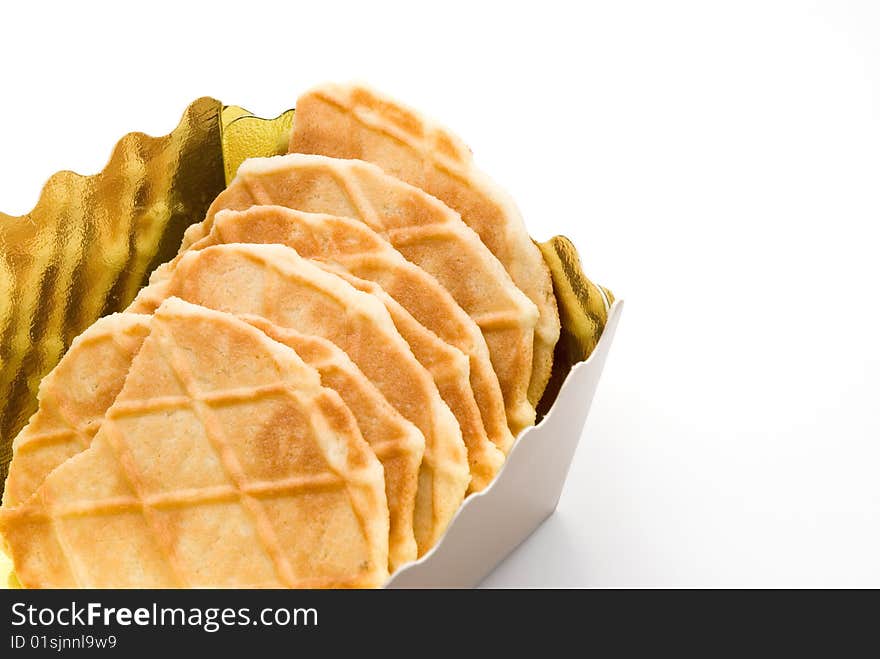 Dry biscuits in a golden box, the white background. Dry biscuits in a golden box, the white background