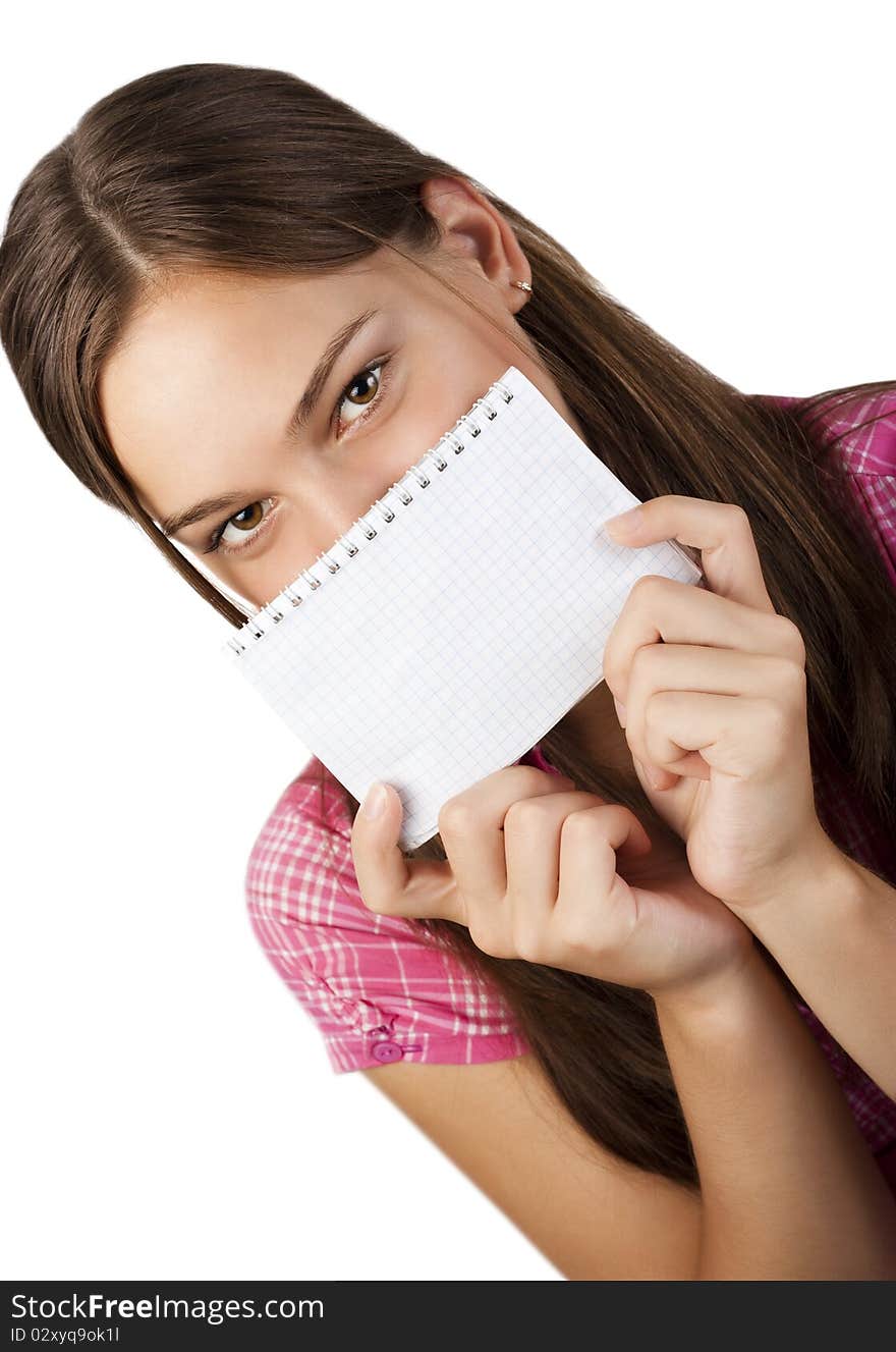 A young girl covers her face with a notebook on a white background. A young girl covers her face with a notebook on a white background.