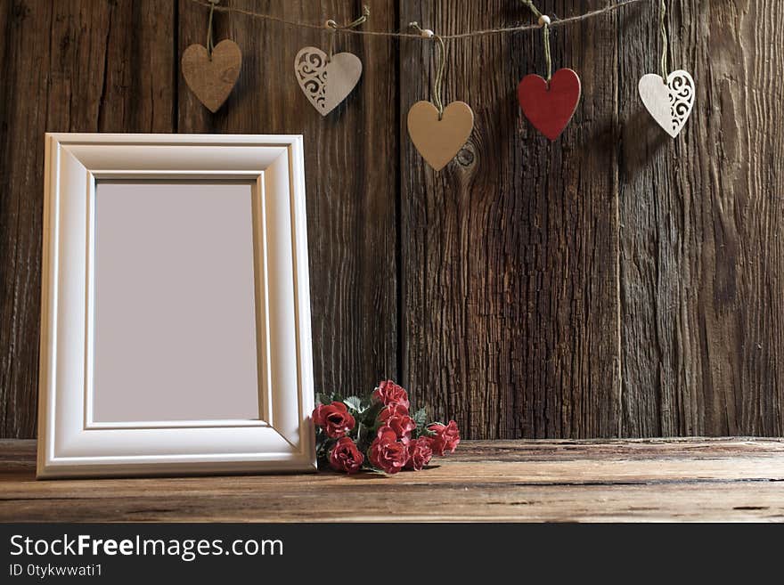 Holiday card for Valentine`s day a glass with red hearts on the background of a vintage lantern and pine branches with the text