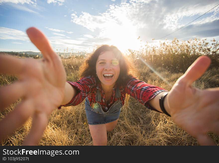 Travel, vacation and holiday concept - Funny young woman taking selfie over beautiful landscape.