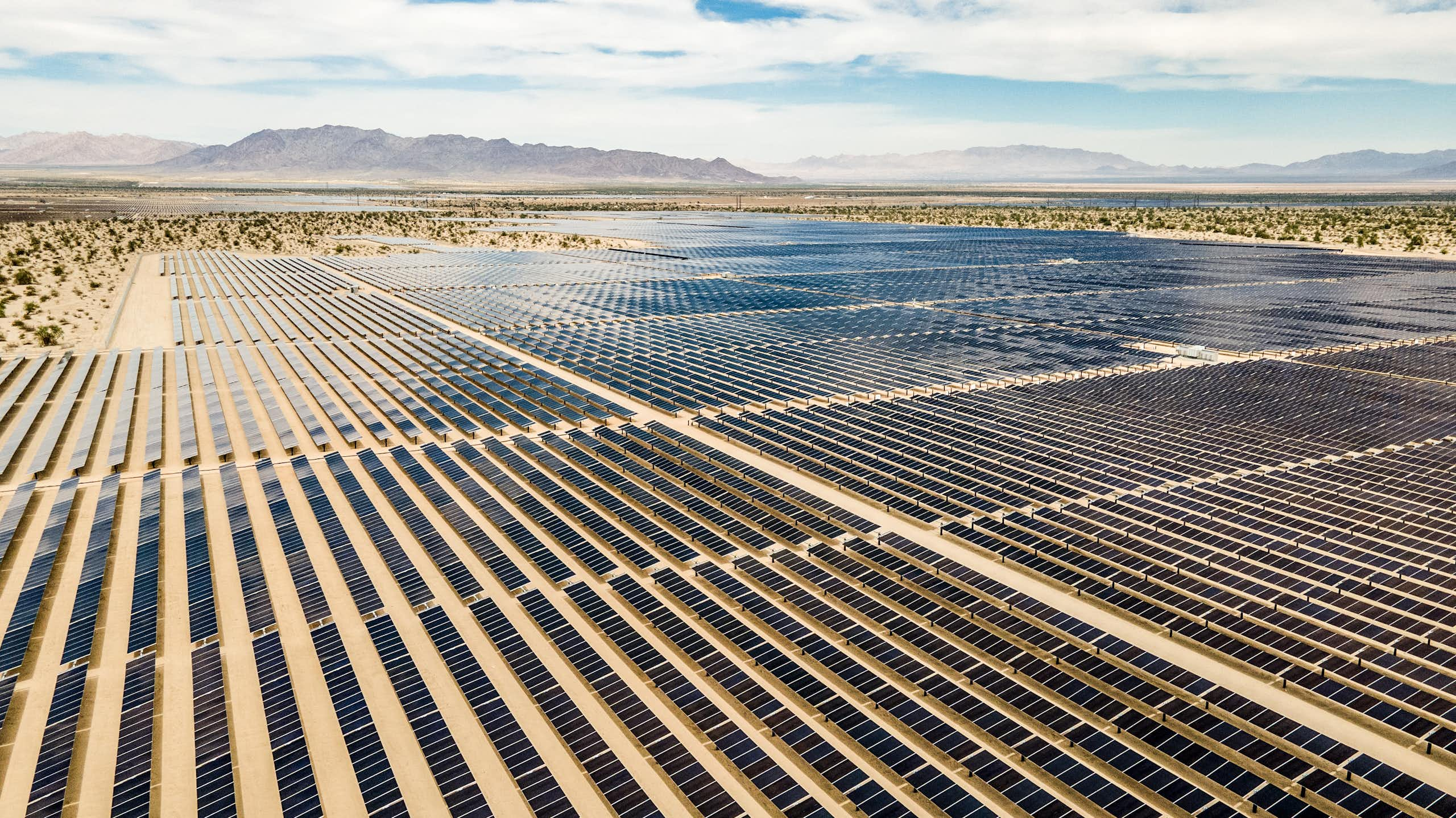 Large arrays of solar panels on desert land