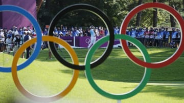 Hideki Matsuyama is seen through the Olympic rings in the fourth round of the Tokyo golf competition in 2021.