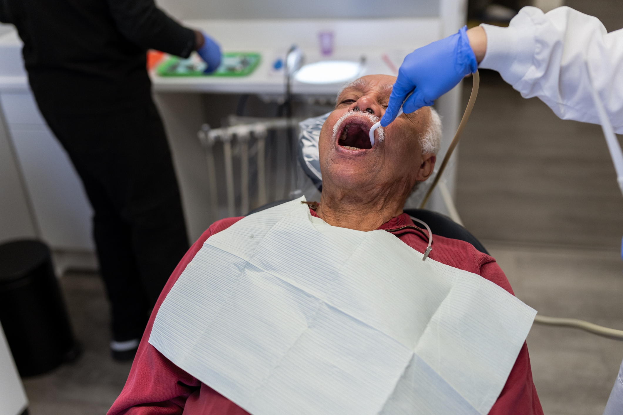 Person receiving dental treatment from a dentist in a clinic