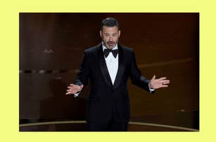 Jimmy Kimmel, dressed in a black tuxedo, makes gestures with his hands while speaking at an event