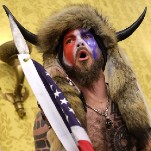 'QAnon Shaman' Excited to Buy 'Some Motha Fu*kin Guns' After Trump Pardon