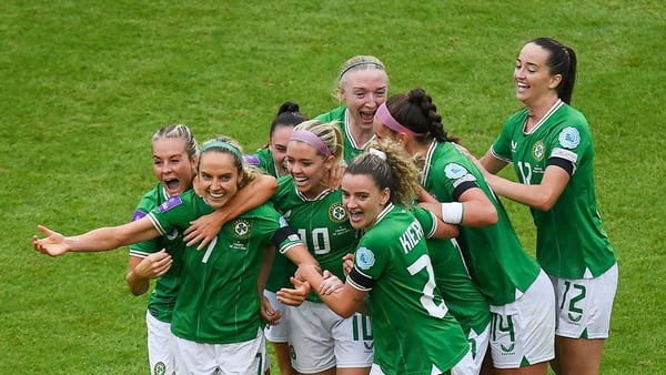 Julie-Ann Russell is mobbed by team-mates after her goal