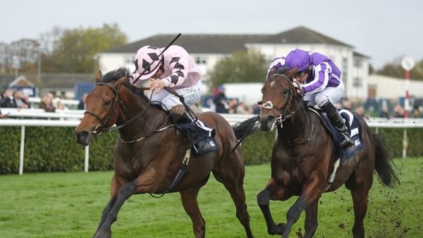 Shane Foley riding Hotazhell (L, pink) pushes clear of Ryan Moore and Delacroix