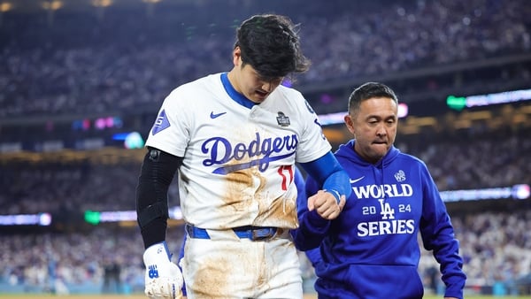 Shohei Ohtani (L) is helped off after suffering an injury