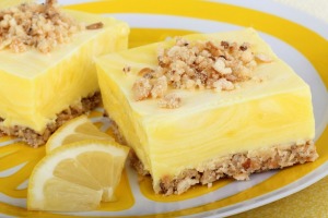 Lemon Squares on a plate with lemon slices.