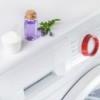 Laundry detergent and lavender on a washing machine.