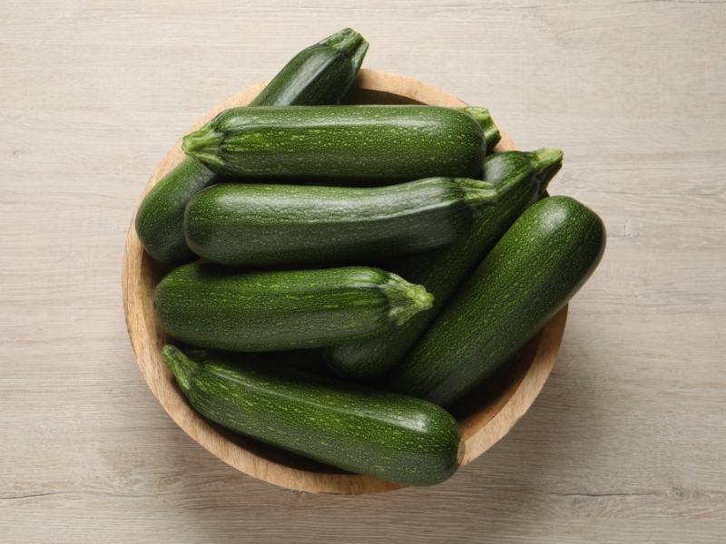 Raw Zucchini in Wooden Bowl