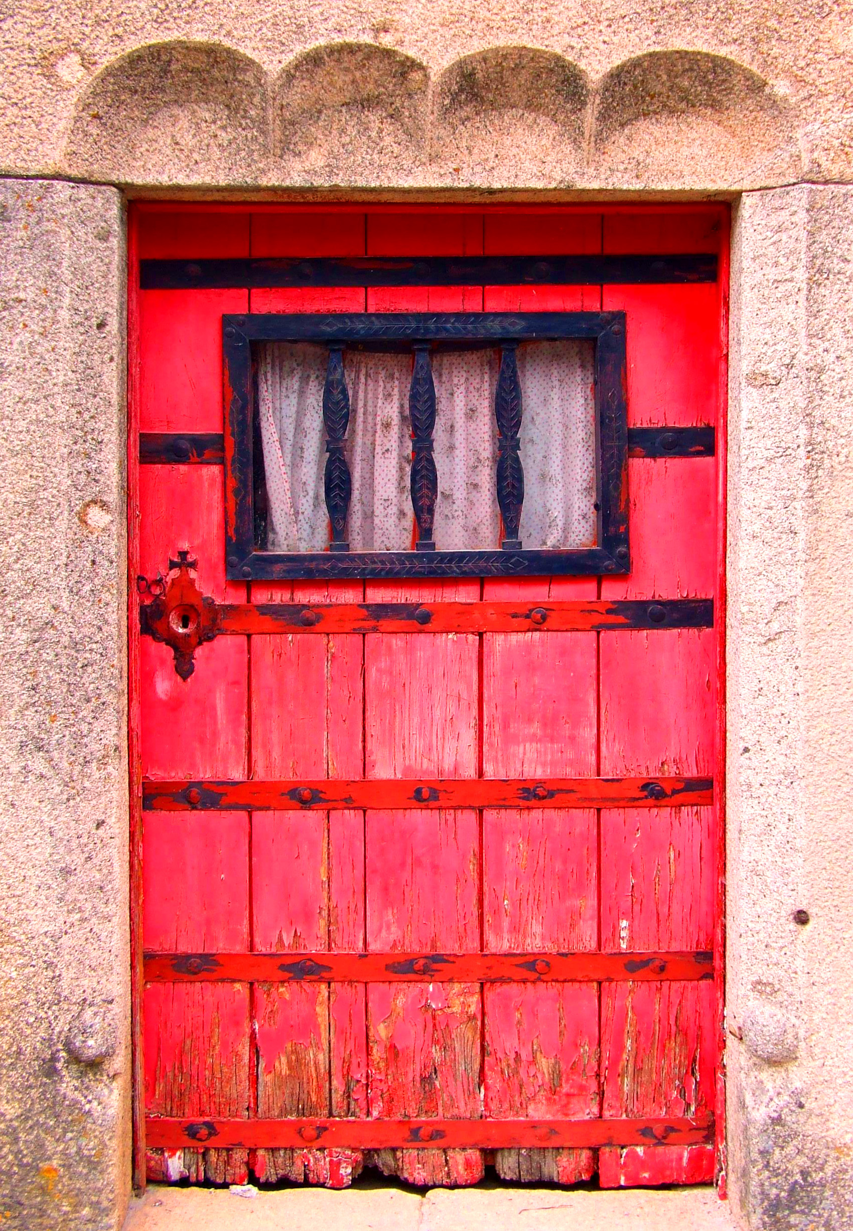 Old red door on a stone building photo