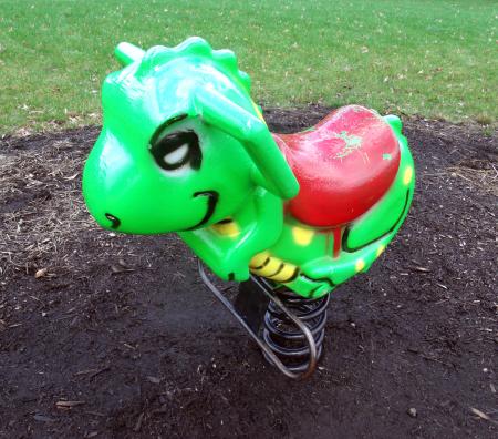 Green playground rocking dinosaur