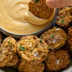 dipping fried pickles in spicy mayo