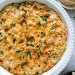 maryland crab dip in a white dish with sliced bread