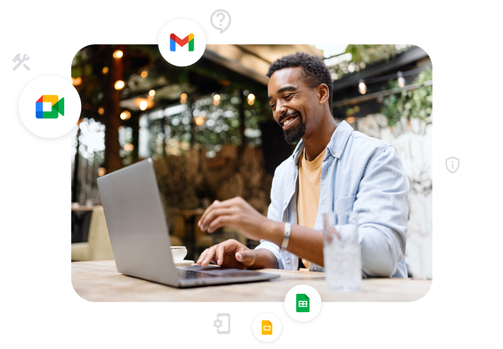 Ilustrasi grafis seorang pelanggan Google Workspace di laptopnya yang menunjukkan ikon untuk Google Meet, Gmail, Slide, dan Spreadsheet. 