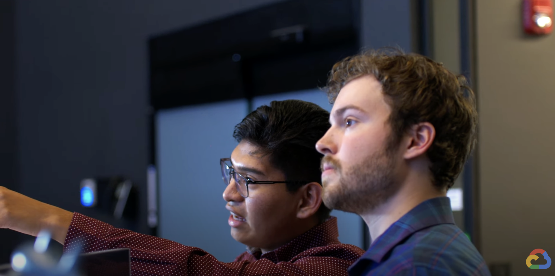 Men pointing to a screen