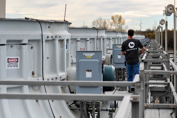 Worker inspecting Mayes County cooling towers