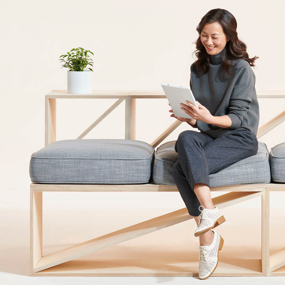 Woman smiles looking at tablet