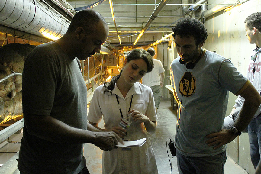 Director DARIN SCOTT and Writer/Producer STEVE KRIOZERE (r.) confer with CHRISTINE DONLON who plays Nurse Violet MacReady.