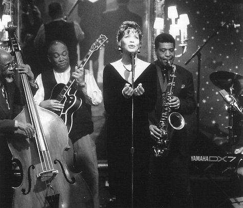 Whitney Houston, George Coleman, Ted Dunbar, and Jamil Nasser in The Preacher's Wife (1996)